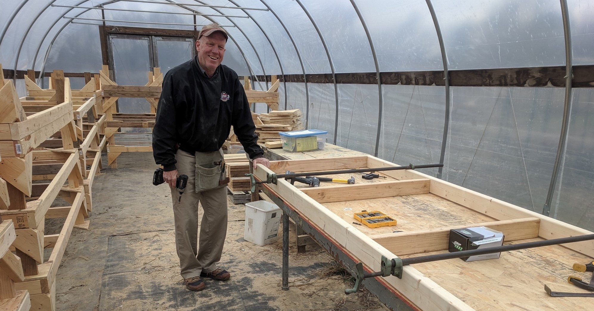 A person building raised garden beds