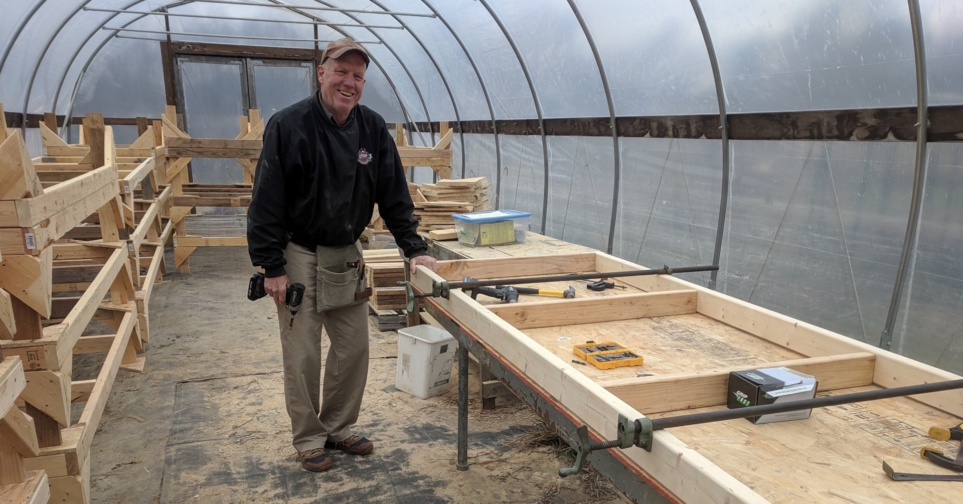 A person building raised garden beds